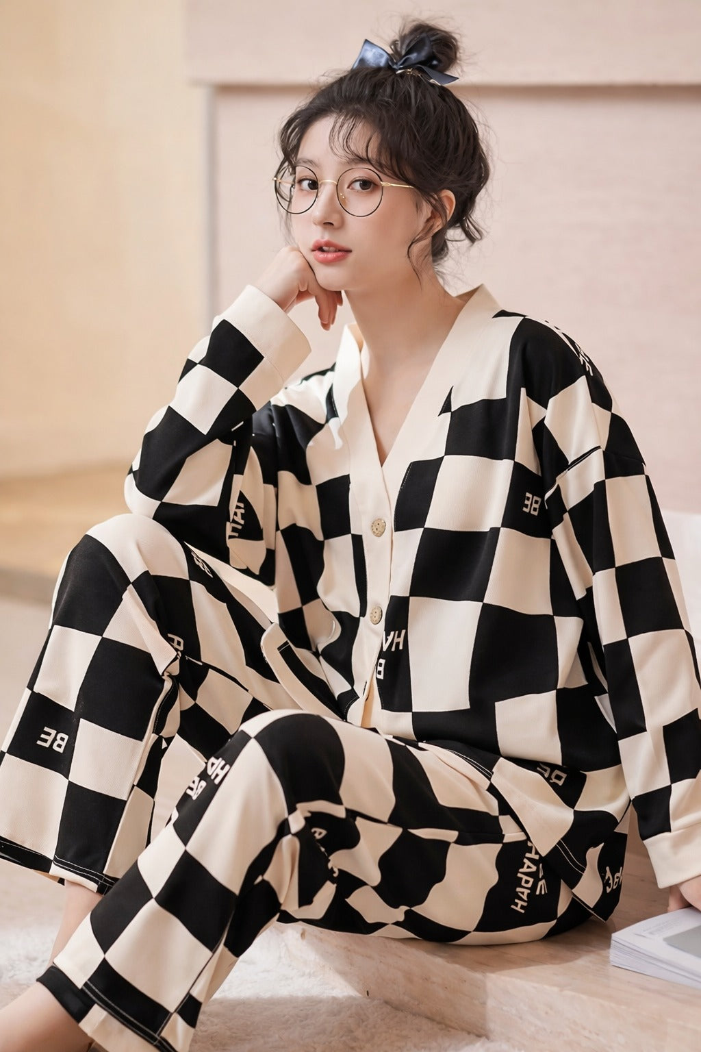 Person wearing a black and white checkered outfit with visible branding.