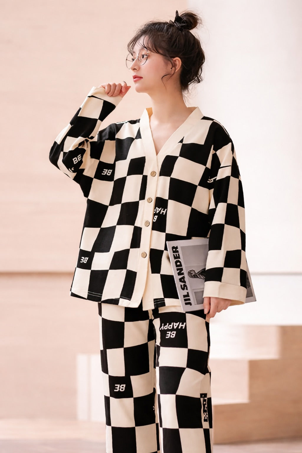 Person wearing a black and white checkered outfit with visible branding.