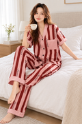Model relaxing on a bed in the striped pajama set